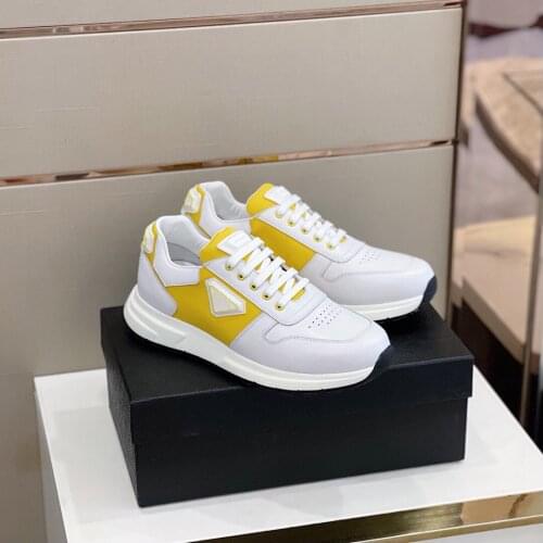 Lace-up sneakers Soft leather uppers with mesh inlays and rubber patterned thick-soled with color-blocking triangle logo design