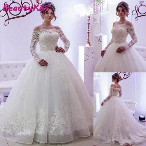 2020 Elegant Ball Gown Wedding Dresses Lace Tulle Boat Neck Long Sleeves Crystals Bridal Gowns
