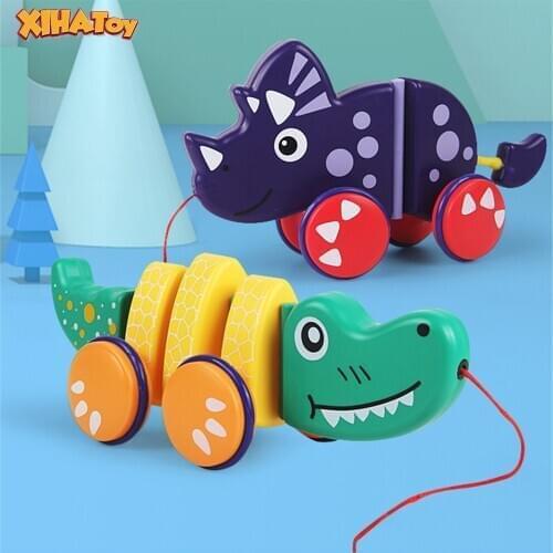 XIHATOY Cartoon Dinosaur Dragging Trailer Walking Training Baby Walk Along Toddler Toy Plastic Towable Car Models Shake Tail