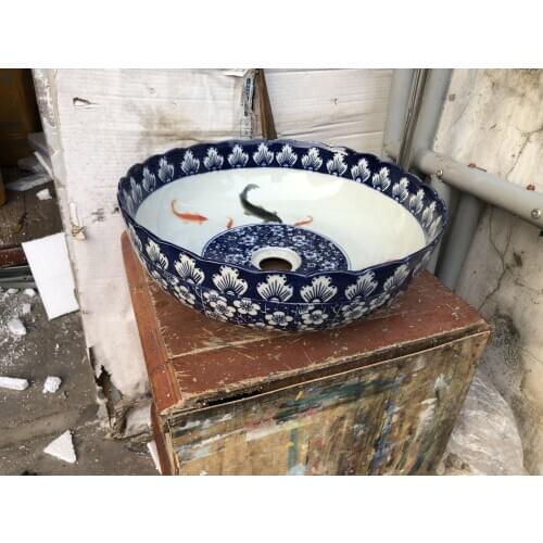 Blue and white ceramic art basin with fish pattern