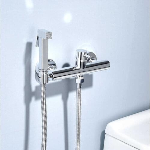 Hot water mixer and cold bathroom bidet female tap flusher spray kit attached to the wall of the chrome shower