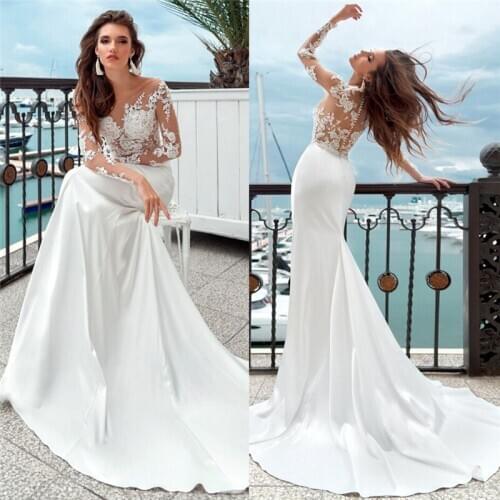 Illusion Sexy Long Sleeves Mermaid Wedding Dresses Lace Appliques With Buttons Back See Through Bridal Dress Spring Trumpet