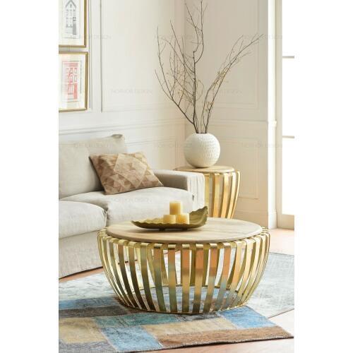 The sitting room tea table. Round, wrought iron golden. Do old coffee table