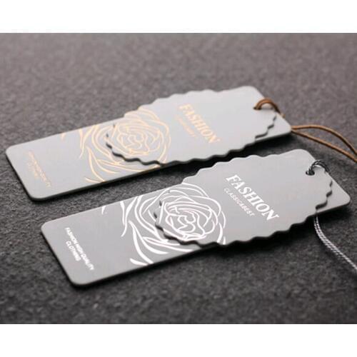 Free design and die cut customized 400gsm paper hang tag for clothing swing garment tags labels printed brand care labels