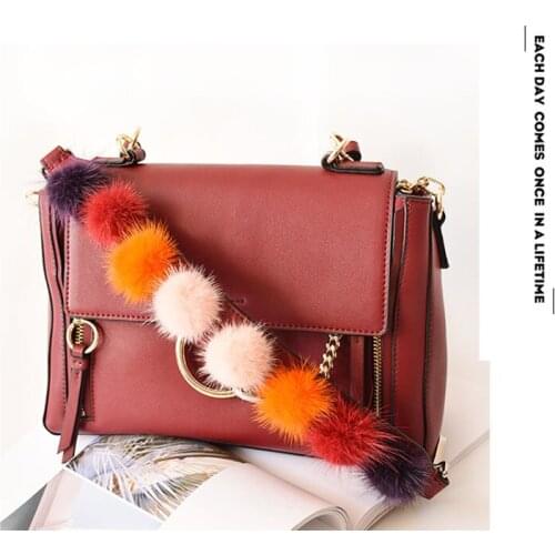 Imported mink fur ball decoration bag with wide leather shoulder strap portable wrist high-end bag accessories 2021 new