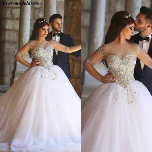 Luxury Long Sleeves Wedding Dresses Ball Gowns 2019 Crystal Beaded Sheer O-Neck Button Back Bridal Gowns Robe De Mariee Sexy