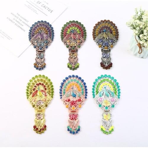 A retro, hollowed-out handle for hot sales is a peacock folding a colored mirror with a portable metal mirror