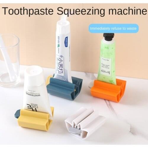 Manual toothpaste squeezer for household use. Lazy hand cream and facial cleanser rolling rack