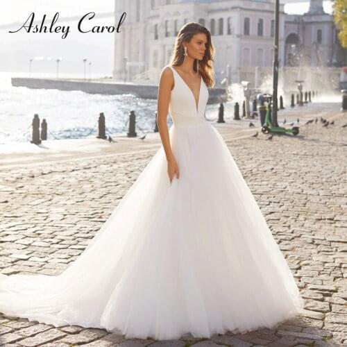 Ashley Carol Ball Gown Wedding Dress 2021 Dreamy V-Neck Sleeveless Bride Backless Chapel Train Puffy Tulle Beach Bridal Dresses