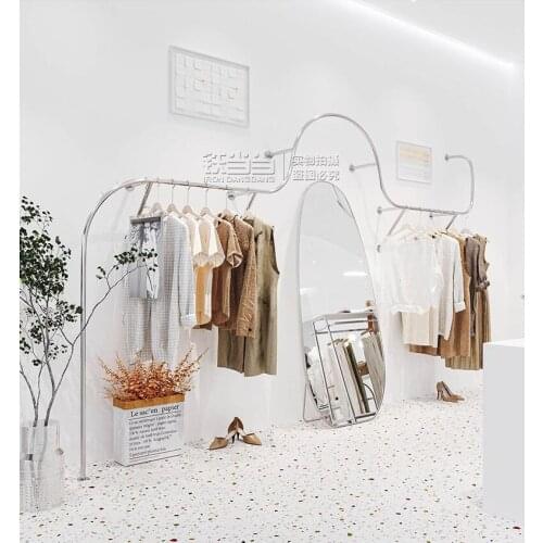 Stainless steel creative clothes hanger on the wall of clothes shelf display rack