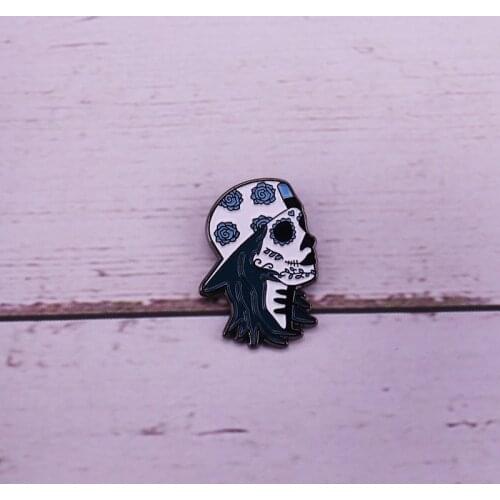Sugar skull skater enamel pin backwards hat with a blue floral pattern brooch
