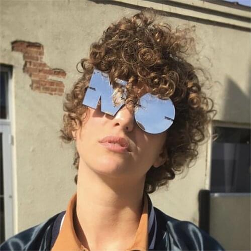 The new NO irregular joker character round sunglasses men and women fashion metal concave shape street snap frameless sunglasses
