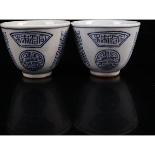 A pair of old Chinese porcelain cups with blue and white shou character pattern