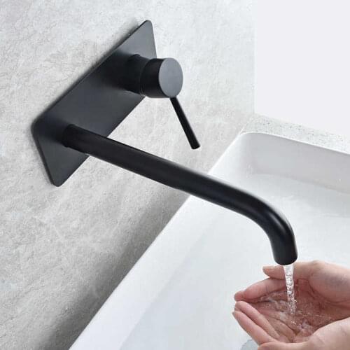 Bathroom basin black and modern faucets of water from the built-in sink mounting on the concealed bronze wall hot and cold