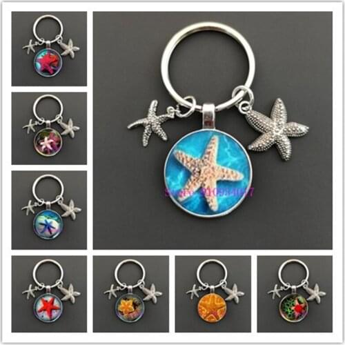 Colored starfish glass cabochon keychain on the beautiful beach full of starfish and shells glass key ring for women and girls