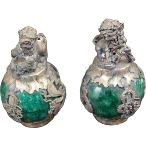 A pair of antique bronze lions and silver coated jade
