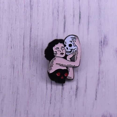 A young lady holding a skull enamel pin Horror jewelry