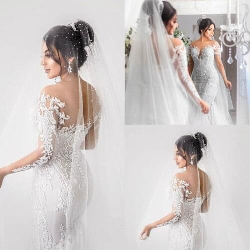 2020 Long Sleeve Mermaid Wedding Dresses Bridal Gowns Sheer Jewel Neck Lace Appliqued Buttons Back Robe de mariee Arabic Wedding