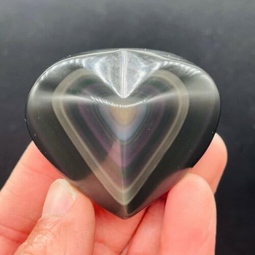 A carved heart of natural obsidian carves a colored lamp
