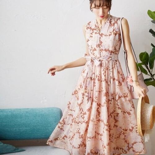 A New Print dress word holding up her full ed dress in the long dress is female