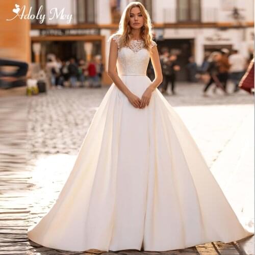 Adoly Mey Romantic Scoop Neck Illusion Back A-Line Wedding Dress 2020 Luxury Beaded Cap Sleeve Appliques Court Train Bridal Gown