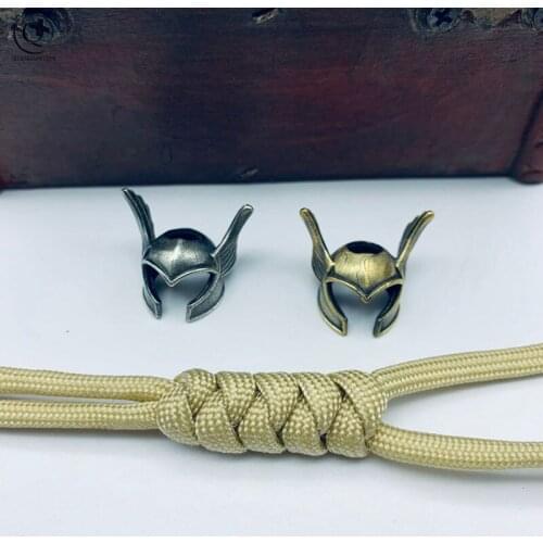 Umbrella Rope Bead Handmade Woven Brass Helmet Keychain Pendants Trinkets Punk Hat with Wings Hanging Knife Bead Lanyard Charms