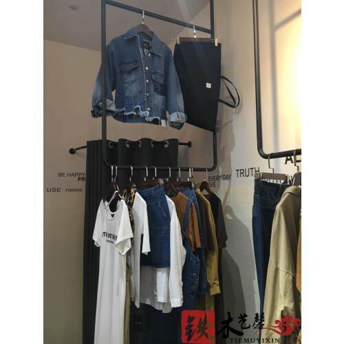 Black and white clothes hanging gantry. Clothing display shelf, display stand, ceiling hangs clothes hangers