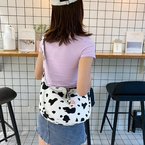 Korean version of large capacity ins cow pattern canvas messenger bag 2020 new womens shoulder bag college style cloth bag