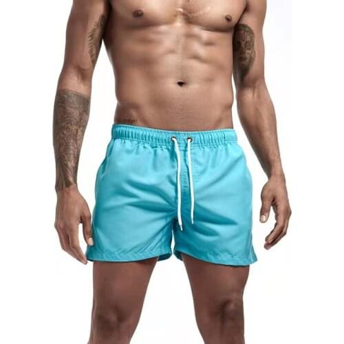 Mens solid color beach swimming surfboard swimsuits and shorts sold well in Europe and America in summer
