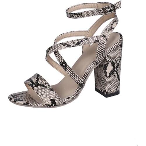 Serpentine strappy high-heeled sandals