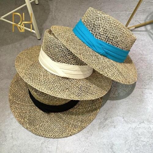 Travel Natural seagrass hollow flat brim hat ladies summer porkpie concave round sun hat beach straw hat with ribbon wholesale