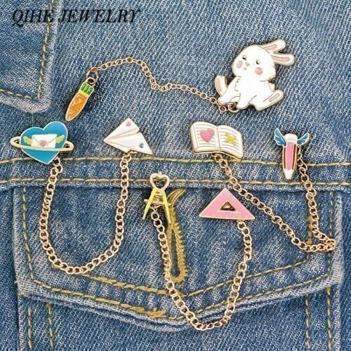 QIHE JEWELRY Cute Tassel Chain Linked Pins Bunny Rabbit Carrot Aircraft Planet Pencil Book Compasses Ruler Enamel Lapel Pins