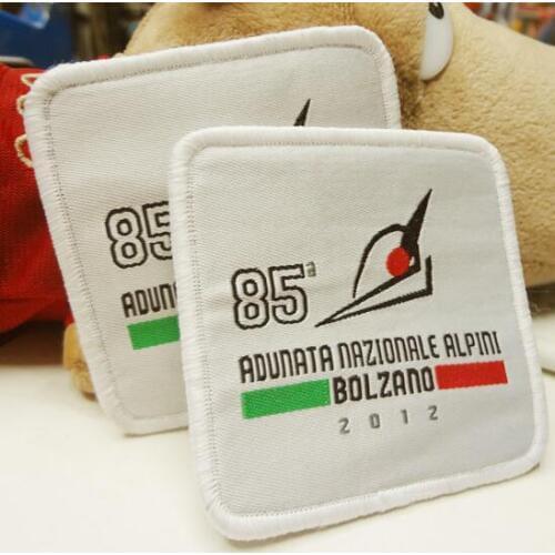 Customized garment iron on woven badge patches, shield stitched merrow border with brand logo for clothes