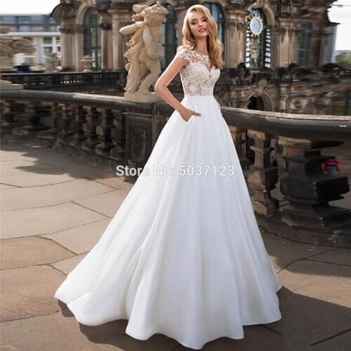 Elegant O Neck A Line Wedding Dresses Lace Appliques Cap Sleeves Vestidos de novia Floor Length Wedding Gown with Pockets 2020