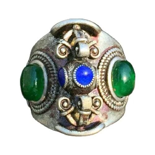 Collection of jewelry with emerald ring face and silver ring head inlaid in folk