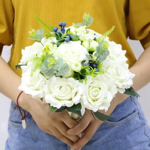 Hand holding flowers forest white rose berry bride holding flower simulation wedding