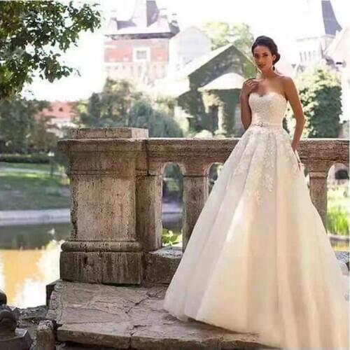 2020 Strapless Light Champagne Wedding Dresses Lace Up Back A Line Bride Dresses Train Illusion Bridal Dress Wedding Gowns