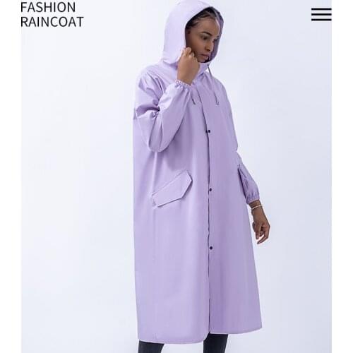 A woman in raincoat has a long full-body rainstorm-proof electric car riding alone on an adult conjoined poncho in summer