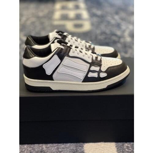 Two-tone low-top sneakers with hollow/carved design front lace-up round head skull applique low-top sneakers leather upper top