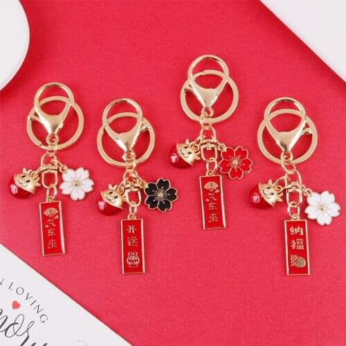 Creative Chinese Red Cow Cerry Flower Keychains for Couples Bag Backpack Clouth Car Keys Pendant for Airpods Case Keyring Gifts