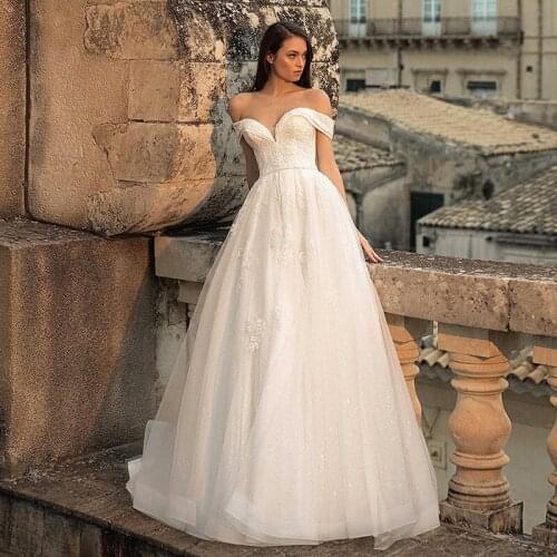 Generous Strapless A-line Wedding Dresses 2021 Sexy Off-the-shoulder Applique Sweep Train Shiny Tulle Bridal Gowns with Belt