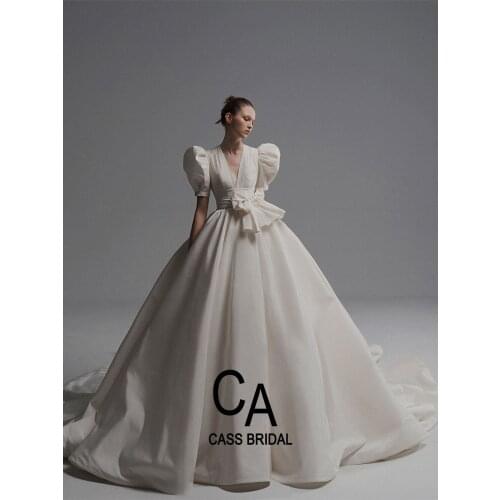 Deep V neckline satin wedding dress pleated bridal gown short puffy sleeves designer 2021 belt bowtie ivory Cathedral Train
