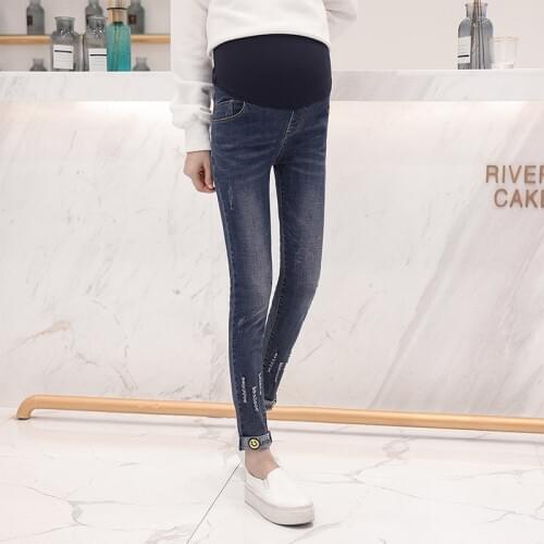 Smiley embroidered maternity dress casual pants stomach lift pants pregnant women hole stretch stomach lift denim pants