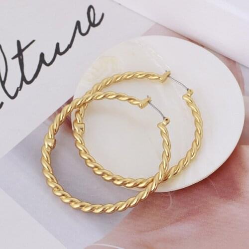 Simple matte golden spiral pattern ear hoop earrings