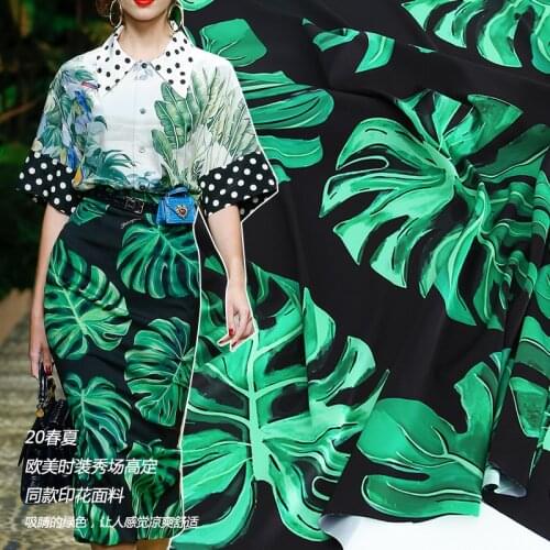 New stretch satin fabric European and American fashion show black background green leaf printing clothing handmade fabric sewing