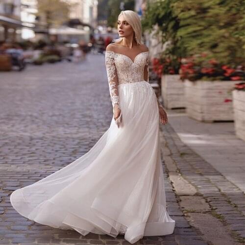 Sheer Scoop neck Long Sleeves A Line Wedding Dresses 2021 Lace Appliques Sparkly Skirt Floor Length Buttons Back Bridal Gowns