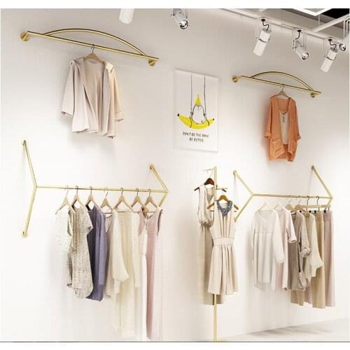 Clothing store display shelf wall womens dress display hanging shelf childrens wear store wall hanging wall golden shelf