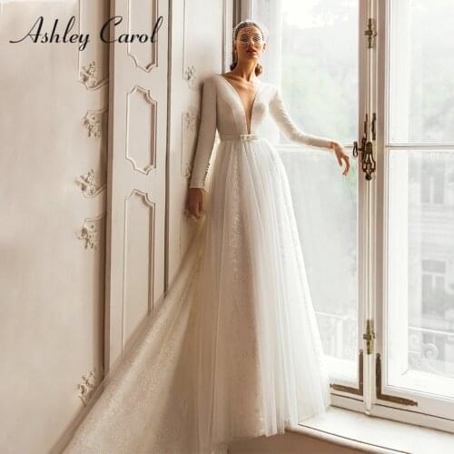 Ashley Carol A-Line Wedding Dress 2021 Classy Deep V-Neckline Long Sleeve Bride Backless Bow Sashes Shimmering Bridal Gowns