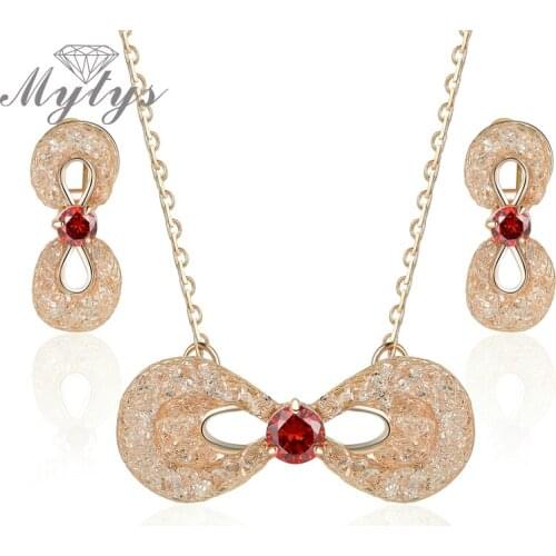 Mytys Sparkling Wire Mesh Net Fill Crystal Bowknot Jewelry sets Pendant Necklace and Earrings Sets Mesh Jewelry for Women CN292