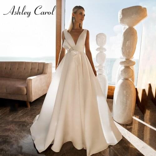 Ashley Carol A-Line Wedding Dress 2021 Elegant Satin V-Neck Backless Beach Bride Dresses Crystal Bow Sleeveless Bridal Gown
